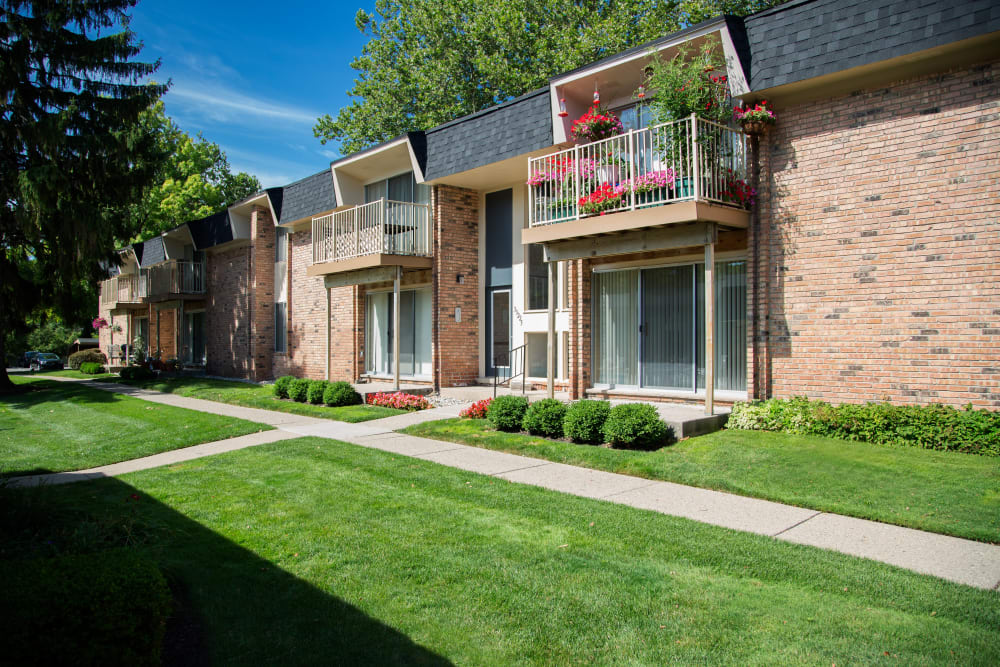 Pathways and well-maintained lawn at Kensington Manor Apartments in Farmington, Michigan