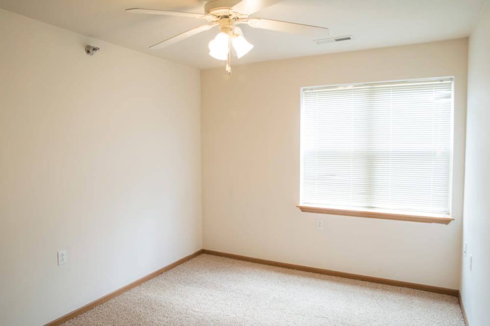 A bedroom with a ceiling fan at West Towne in Ames, Iowa
