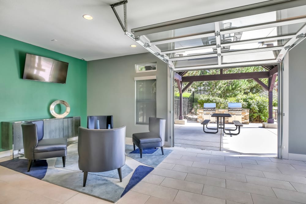 Indoor / Outdoor Lounge & BBQ Area at The Pines at Castle Rock Apartments in Castle Rock, Colorado
