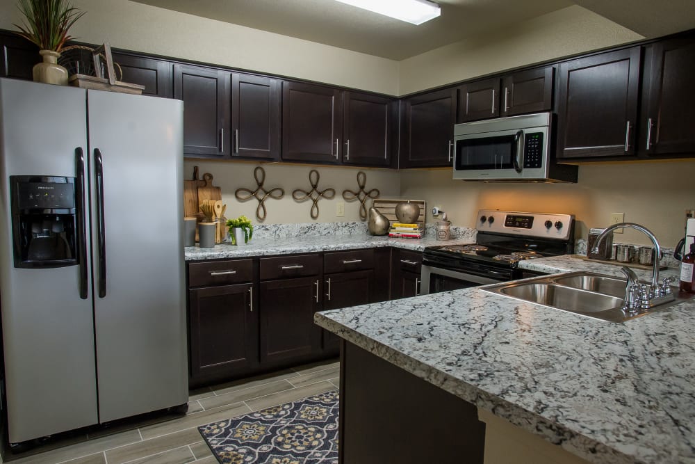 Kitchen with granite counters at Icon at Corpus Christi in Corpus Christi, Texas