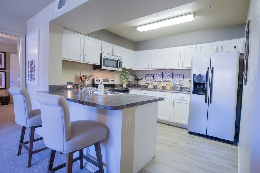 Kitchen with bar seating of Mission Point Apartments in Moore, Oklahoma