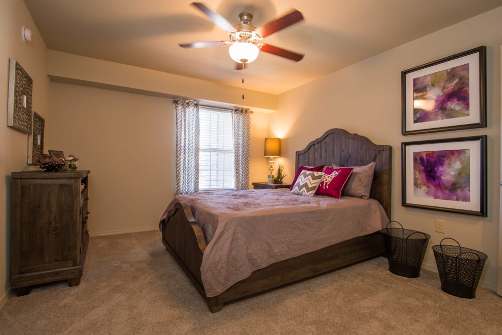 Bedroom with a ceiling fan at Mission Point Apartments in Moore, Oklahoma