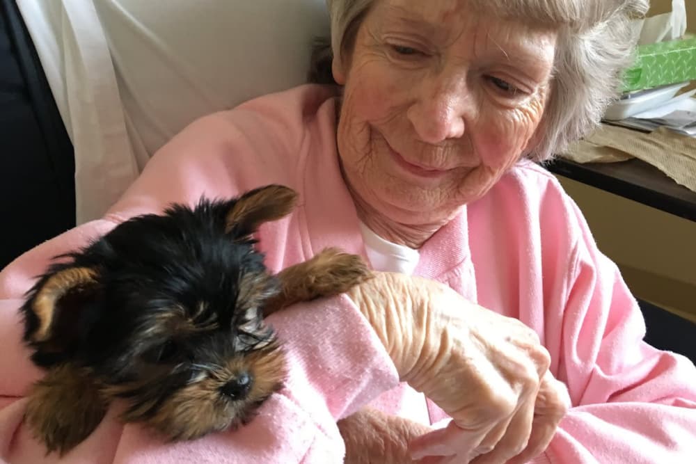 A happy resident holding her Yorkie at Forest Glen Health Campus in Springfield, Ohio