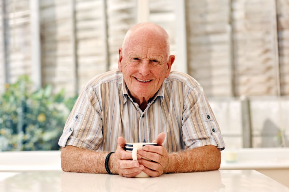 Senior resident having a laugh outside Vista Village Senior Living in Vista, California