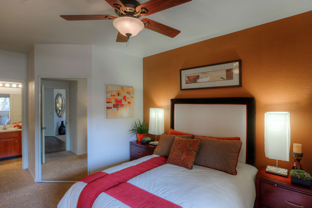 Large master bedroom with ceiling fan and beautiful furnishings in model home at San Marbeya in Tempe, Arizona