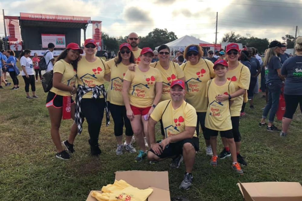  WRH Realty Services, Inc employees take a group photo at a local activity dressed in team colors