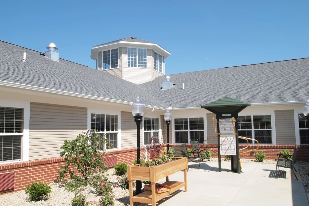 Community patio with seating and a planter box at The Willows at Willard in Willard, Ohio