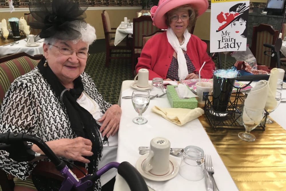Two residents dressed up in the dining room at Westport Place Health Campus in Louisville, Kentucky
