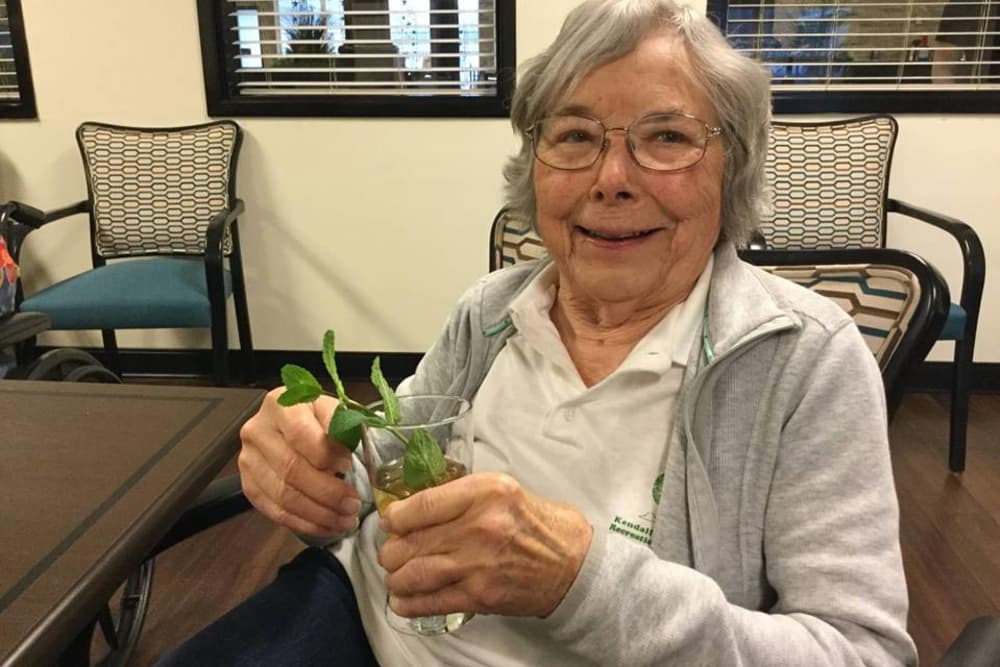 A resident enjoying a drink at Orchard Pointe Health Campus in Kendallville, Indiana