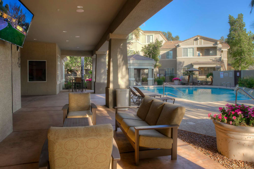 Swimming pool area with covered lounge seating nearby at The Reserve at Gilbert Towne Centre in Gilbert, Arizona