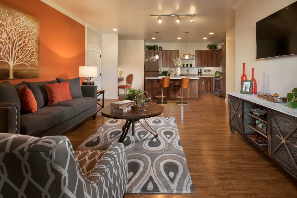 Gourmet kitchen with granite countertops and adjacent workspace in model home at San Valencia in Chandler, Arizona