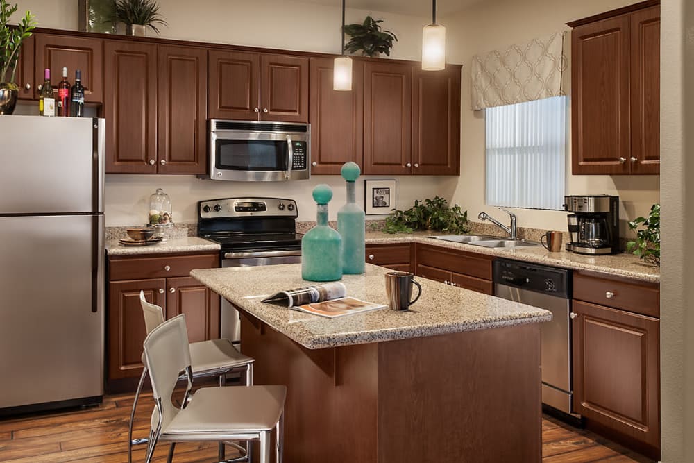 Gourmet kitchen with granite countertops and an island at San Norterra in Phoenix, Arizona