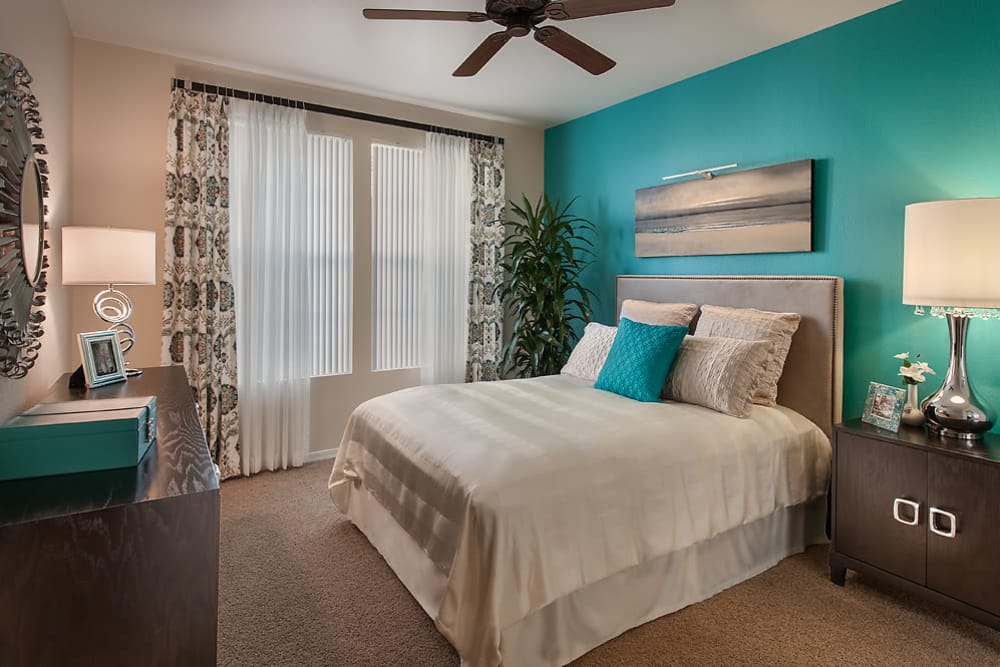 Large master bedroom with ceiling fan and beautiful furnishings in model home at San Norterra in Phoenix, Arizona