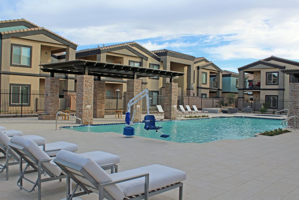 Sundeck with poolside lounge chairs at The Maxx 159 in Goodyear, Arizona