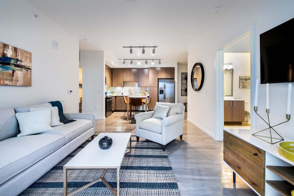 Spacious living room and kitchen with hardwood flooring in a home at Elevate in Englewood, Colorado