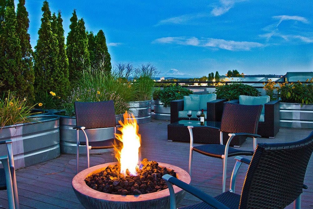 Cozy firepit with views of Mount Rainier on the rooftop deck of The Corydon in Seattle, Washington
