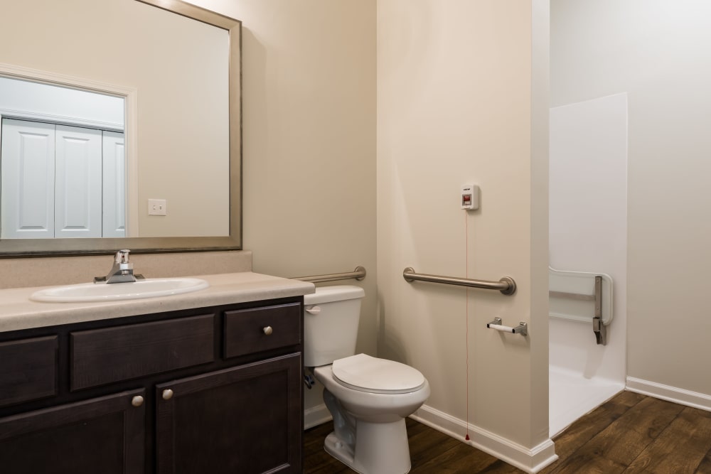 Restroom with a stand up shower at The Mansions at Alpharetta Assisted Living and Memory Care in Alpharetta, Georgia