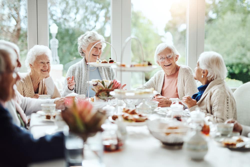 Group of women residents enjoying brunch at Avenir Memory Care at Scottsdale in Scottsdale, Arizona. 