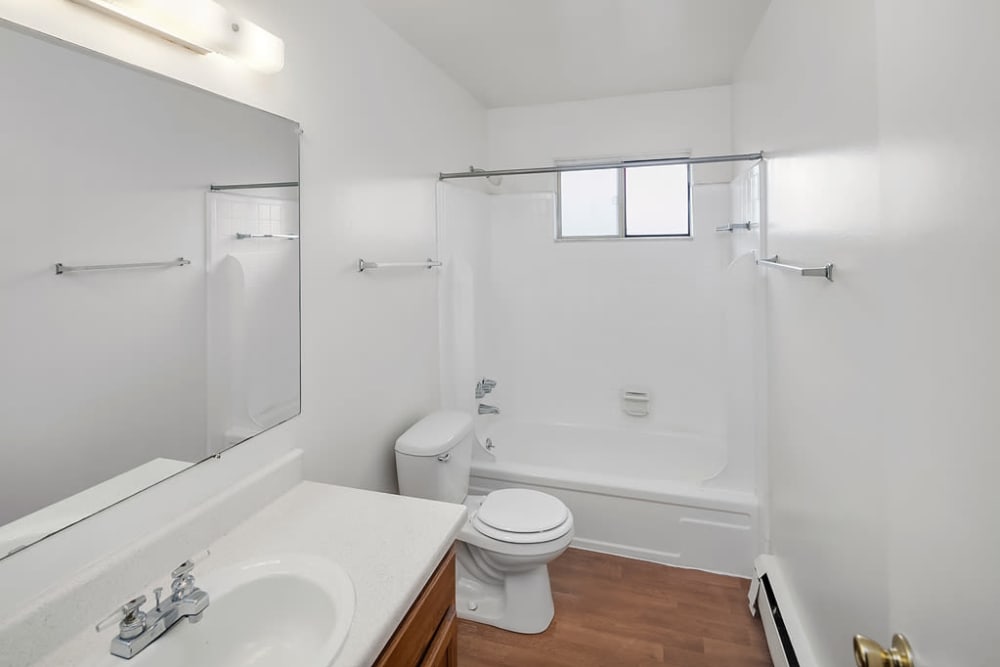 A bathroom with a bathtub at Concorde Club Apartments in Romulus, Michigan