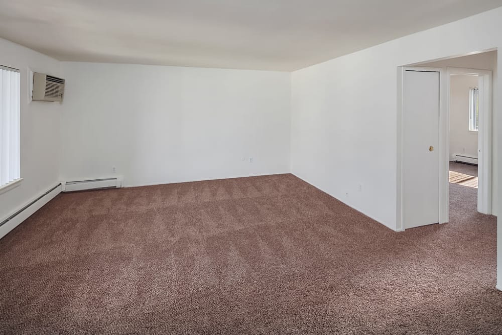 Living room leading to the bedroom at Concorde Club Apartments in Romulus, Michigan