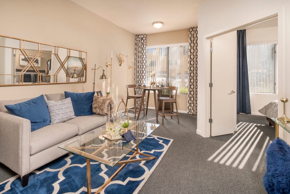 Living room with a ceiling fan and beautiful furnishings in a model home at Tempe Metro in Tempe, Arizona