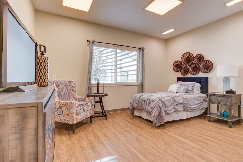 A bedroom with hardwood floors at Juniper Springs Senior Living in Redmond, Oregon. 