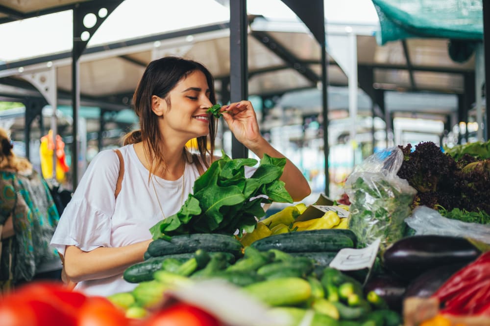 Resident buying produce at the local farmers market in Riverside, California near The Trails at Canyon Crest
