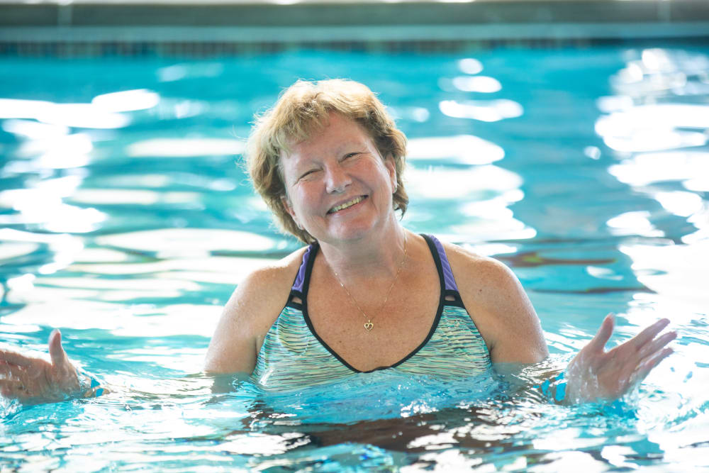 A happy resident in the pool at Touchmark Health & Fitness Club in Meridian, Idaho