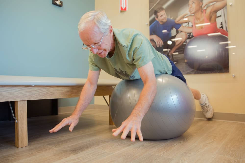 A resident on a yoga ball at Touchmark Health & Fitness Club in Meridian, Idaho