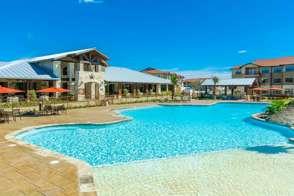 Large pool area with beach entryway at Legacy Brooks in San Antonio, Texas