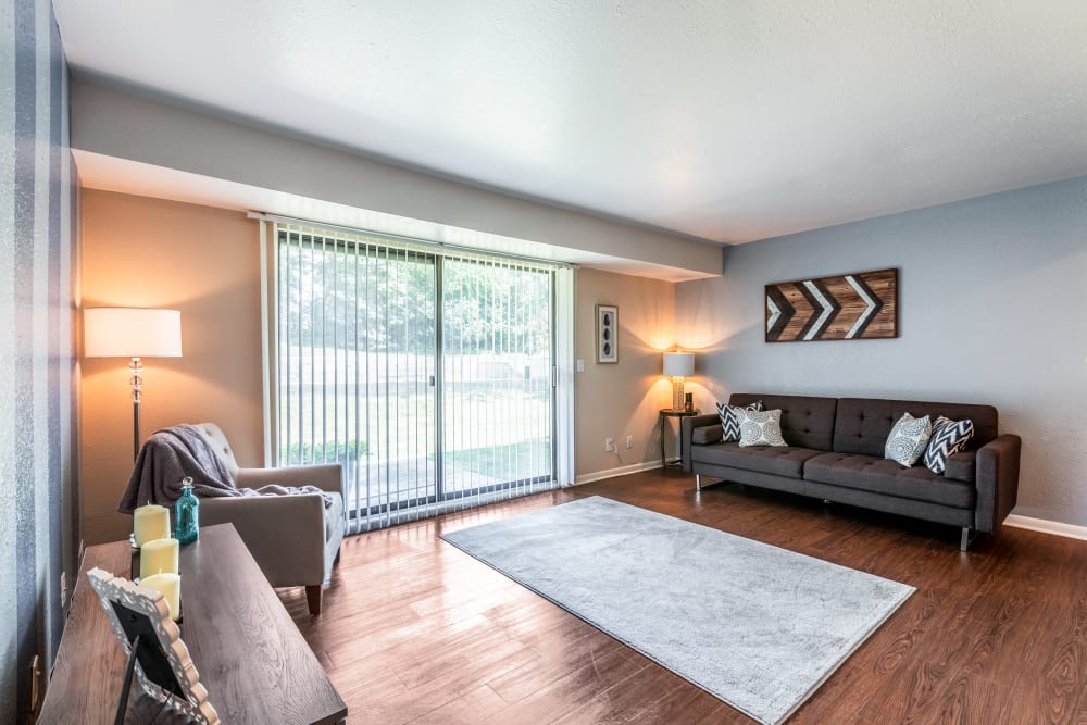 Living room with patio access at Okemos Station Apartments in Okemos, Michigan