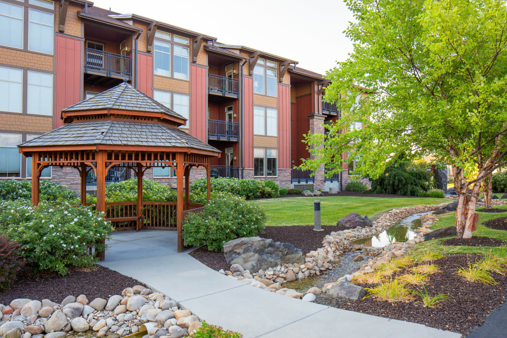 Apartment buildings with a view of the courtyard at Touchmark at Meadow Lake Village in Meridian, Idaho