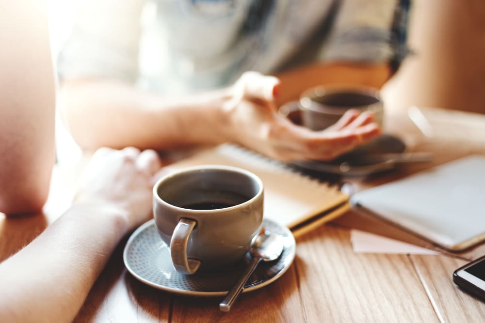 Two cups of coffee sitting on a table at Keystone Place at LaValle Fields in Hugo, Minnesota