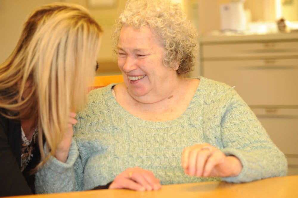 A senior laughing with their caretaker at Chandler House in Yakima, Washington
