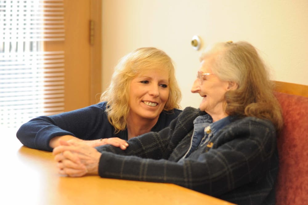 A senior sitting down with their caretaker at Chandler House in Yakima, Washington