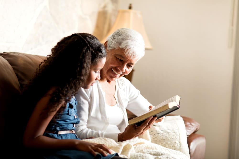 A resident reading to a young child at The Courtyards at Linden Pointe in Winnipeg, Manitoba