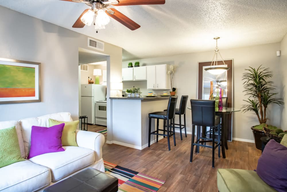 Model dining area and living room at Willowick Apartments in College Station, Texas