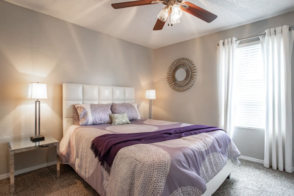 Bedroom with large windows at Willowick Apartments in College Station, Texas