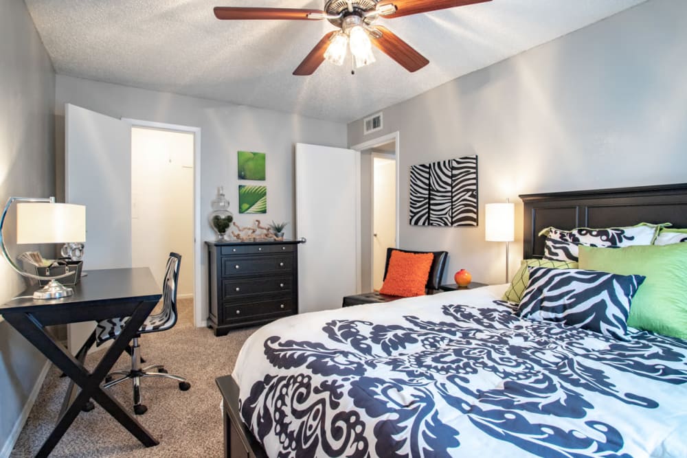 Model bedroom with attached bathroom at Willowick Apartments in College Station, Texas
