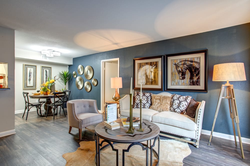 Model living room with view to dining room at 2400 Briarwest in Houston, Texas