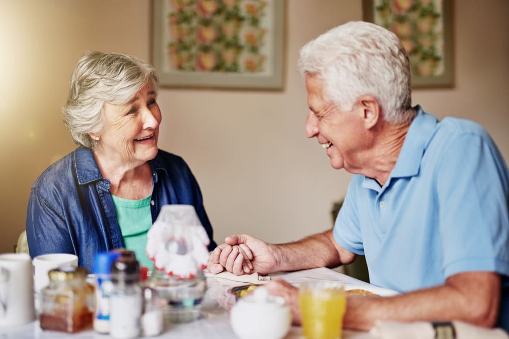 A happy couple having a meal together at Brightwater Senior Living of Linden Ridge in Winnipeg, Manitoba