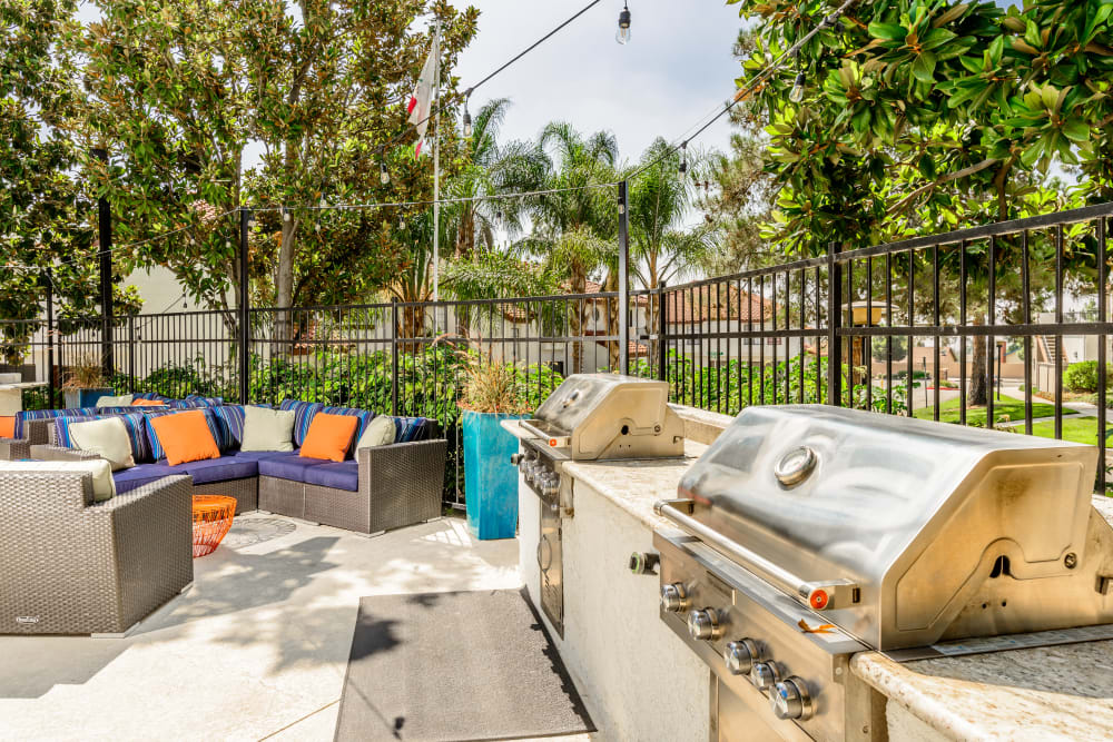 Barbecue area with comfortable seating for entertaining friends at Sonora at Alta Loma in Alta Loma, California