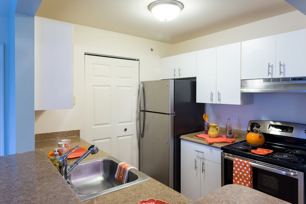 Kitchen with black appliances at Waters Edge Apartments in Lansing, Michigan
