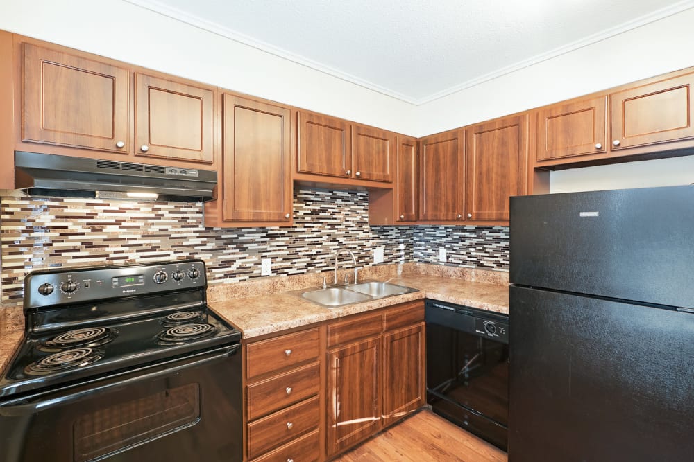 Kitchen with wood cabinets at The Hills at Oakwood Apartment Homes in Chattanooga, Tennessee