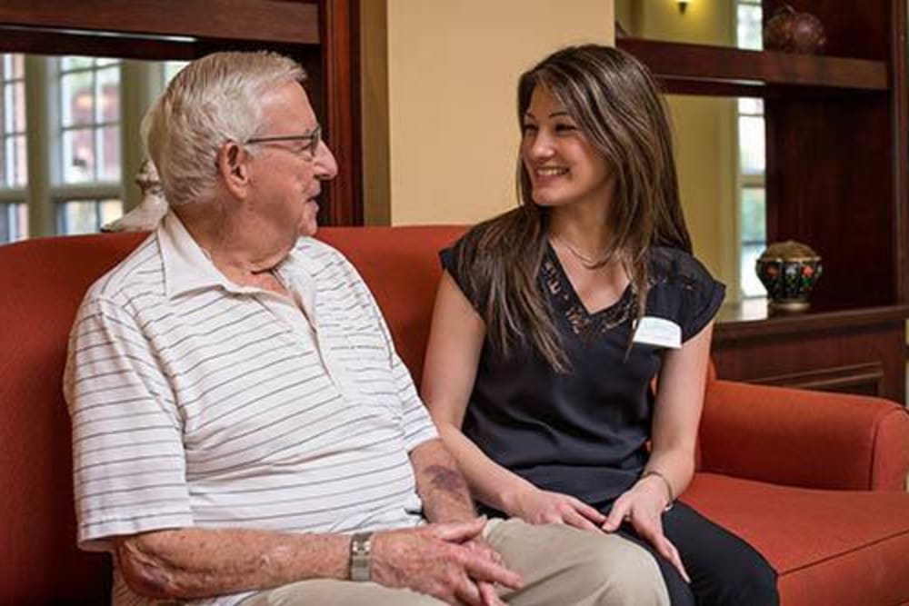 Resident talking to a caregiver at WellQuest of Menifee Lakes in Menifee, California