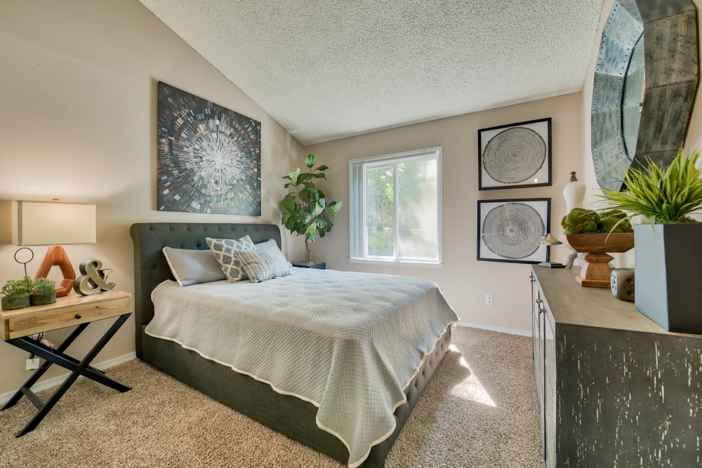 Well lit bedroom with carpeted floors at Lakeside Landing Apartments in Tacoma, Washington