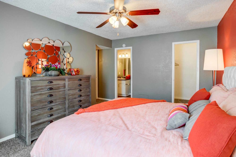 Model bedroom with ceiling fan at Sausalito Apartments in College Station, Texas