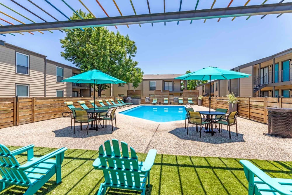 Resort style pool area with lounge seating at Sausalito Apartments in College Station, Texas
