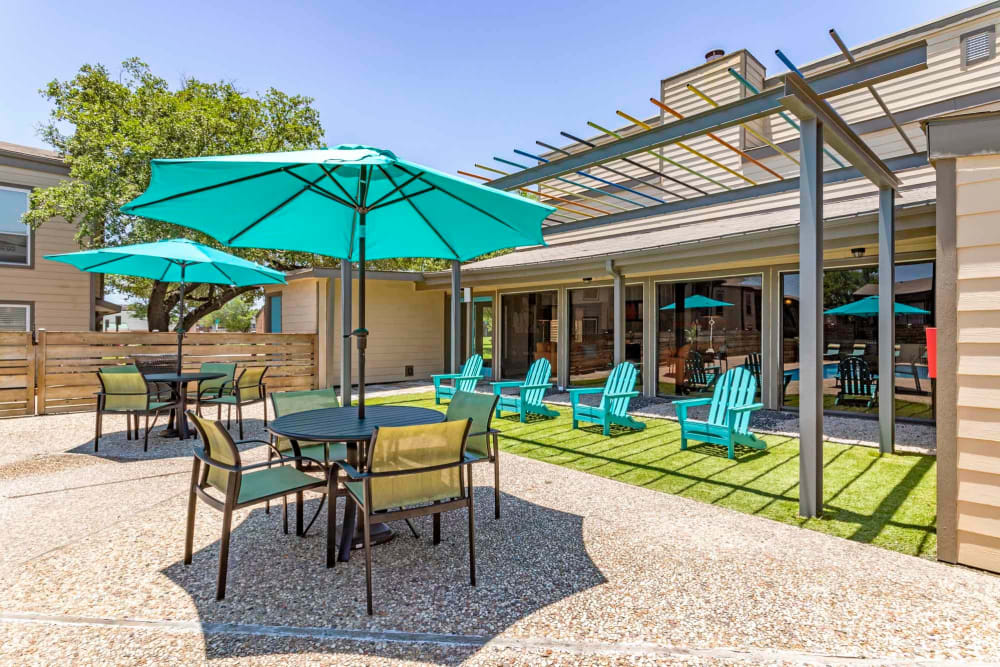 Outdoor picnic and lounge area by the pool at Sausalito Apartments in College Station, Texas