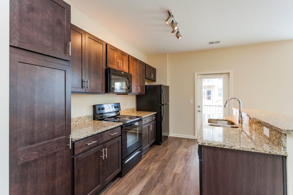 Full kitchen featuring hardwood floors at Madison Crest Apartment Homes in Madison, Tennessee